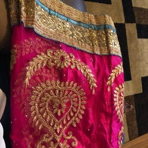 Saree and unstitched blouse and skirt.